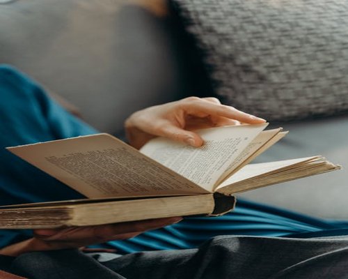 Person reading a book in a quiet room for relaxation