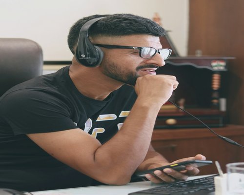 Person drinking water at office desk in India